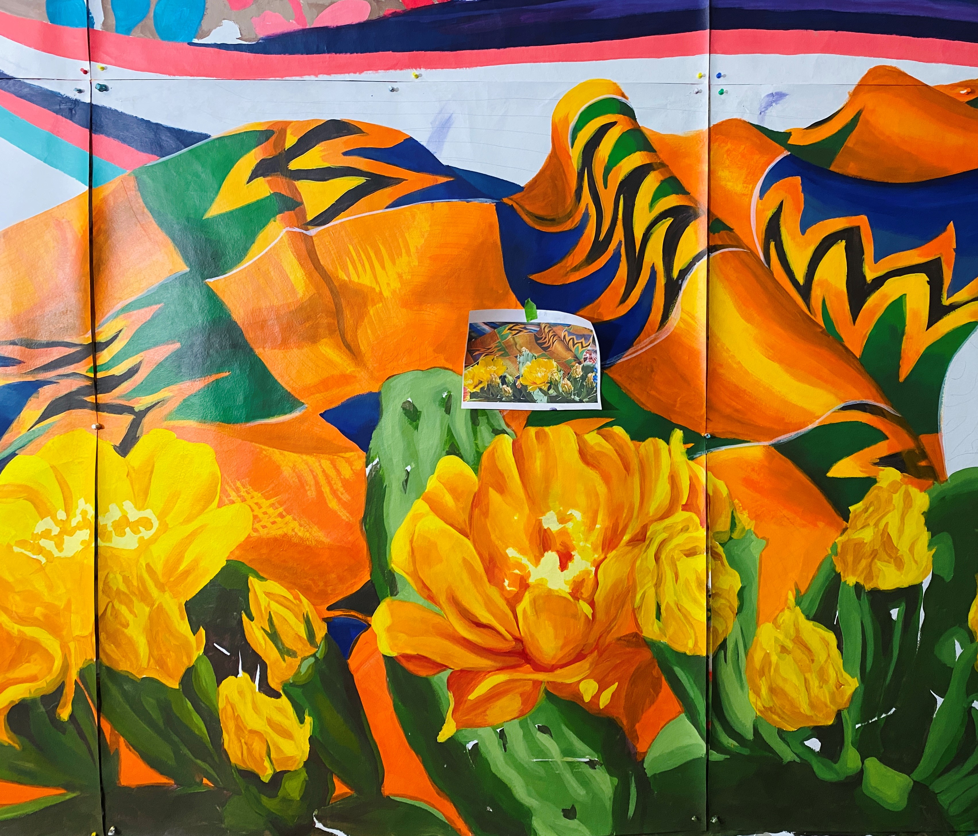 Mural in progress. Showing unfinished flowers and fabric.