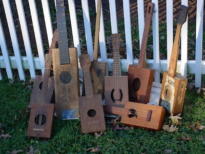 A collection of antique cigar box guitars, banjos and ukuleles. From the National Cigar Box Guitar Museum.