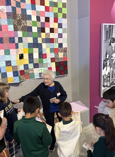 Docent speaking to students in the museum.