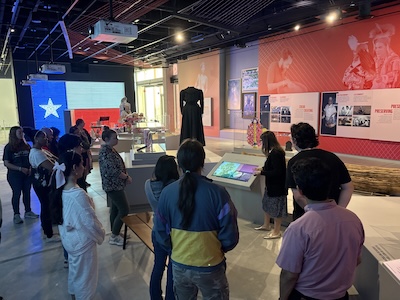 Monica Perales, associate vice provost for the Institute of Texan Cultures, explains to a UTSA public history class how the institute&rsquo;s new exhibit floor incorporates interactive technology and digital experiences, adding depth to the museum experience. 
