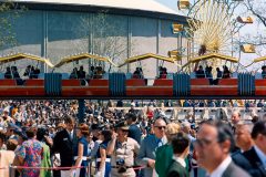 Crowd shot, with monorail, Ferris Wheel, and arena in background
