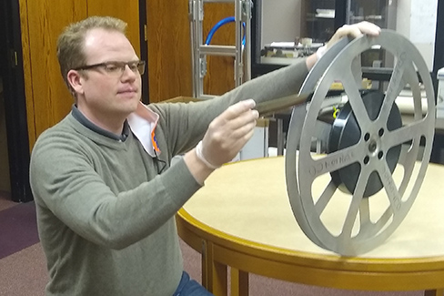 Barrett Codieck examines one of the old reels from the collection