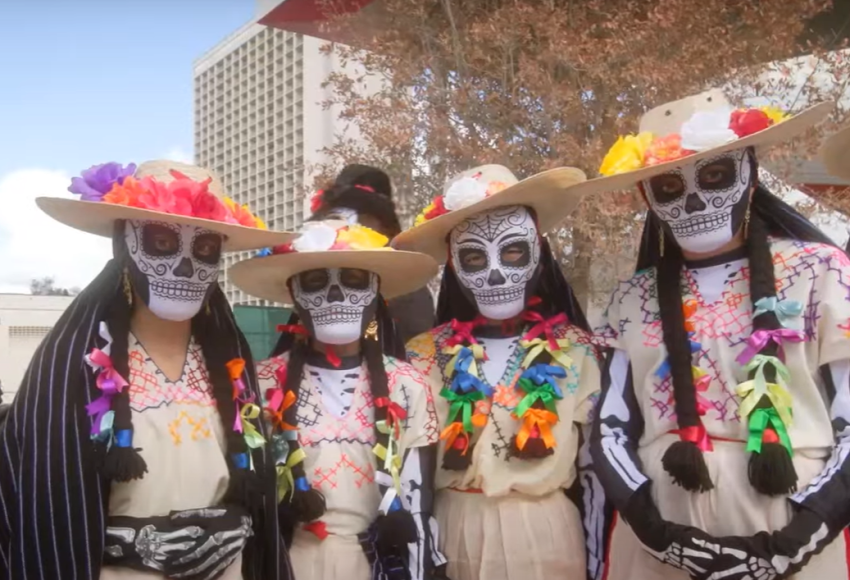 Group of 4 people in sugar skull outfits